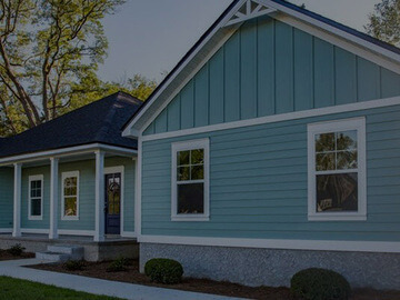 Residential home with blue horizontal siding and white trim