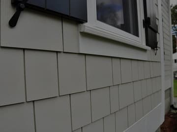 Close-up of fiber cement siding installed beneath a window