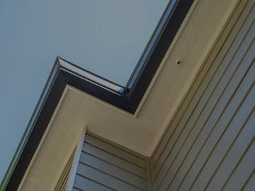 Soffit and fascia detail at roofline corner of a finished home