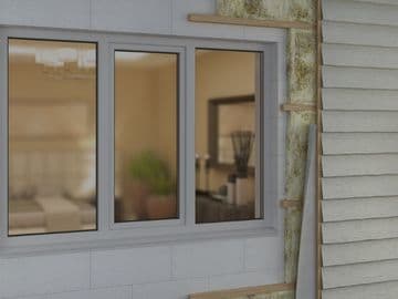 Close-up view of a home exterior during siding installation, showing a modern window, exposed insulation, and partially installed horizontal siding panels.